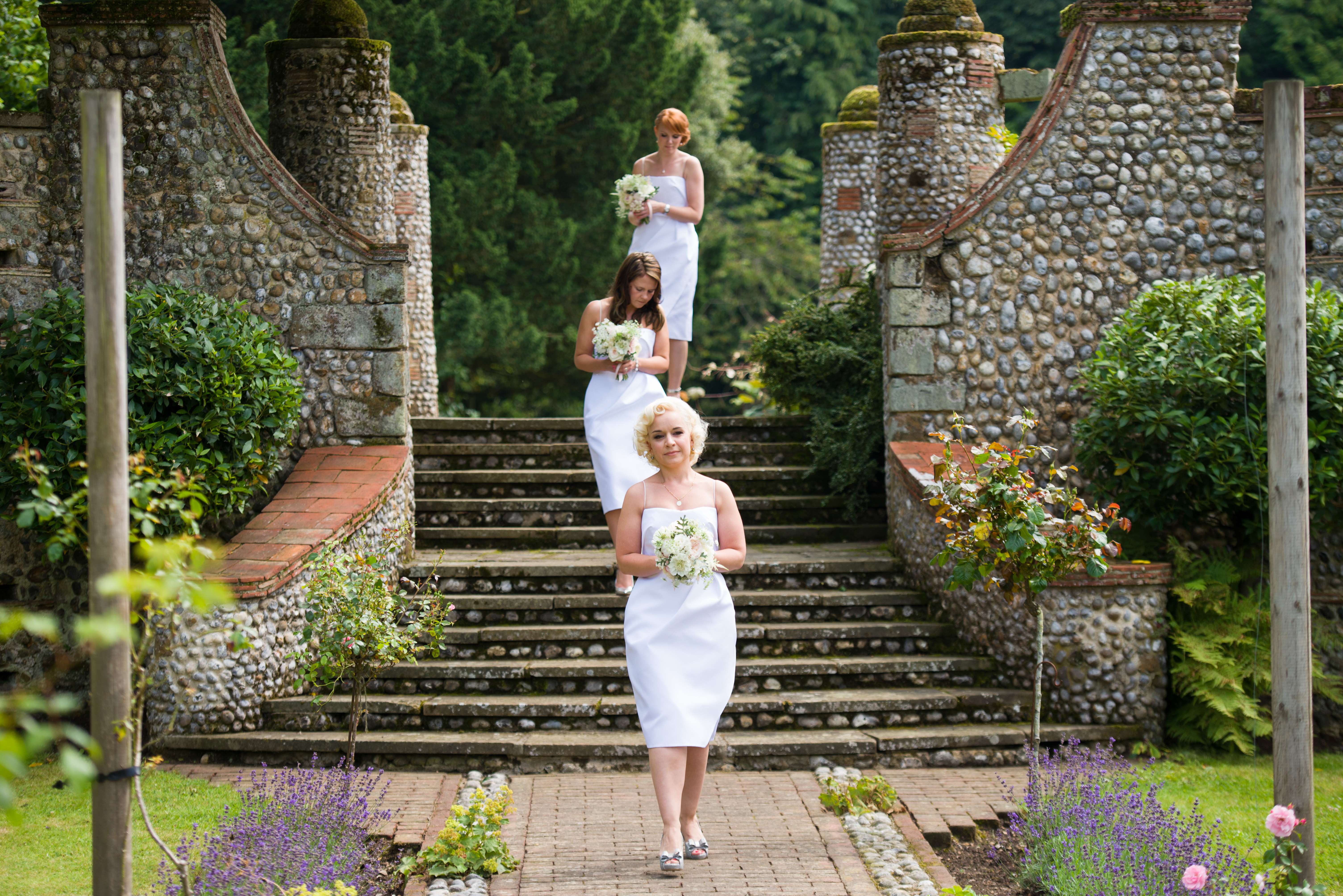 bridesmaids walking to outdoor ceremony at voewood wedding
